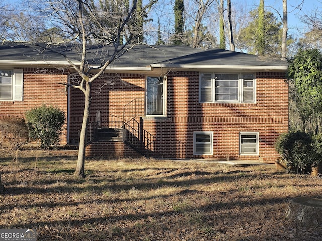 view of home's exterior featuring a lawn and brick siding