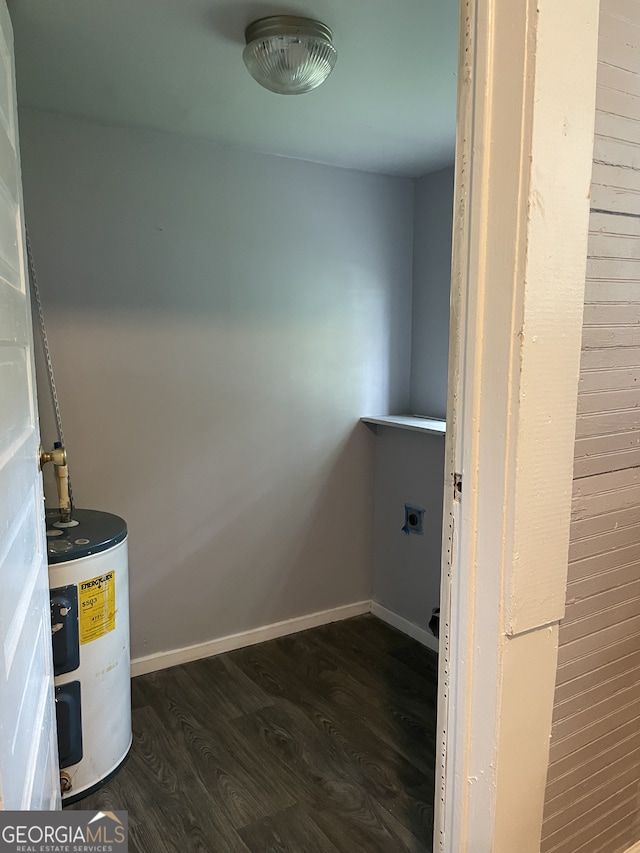 clothes washing area with electric dryer hookup, water heater, and dark hardwood / wood-style flooring