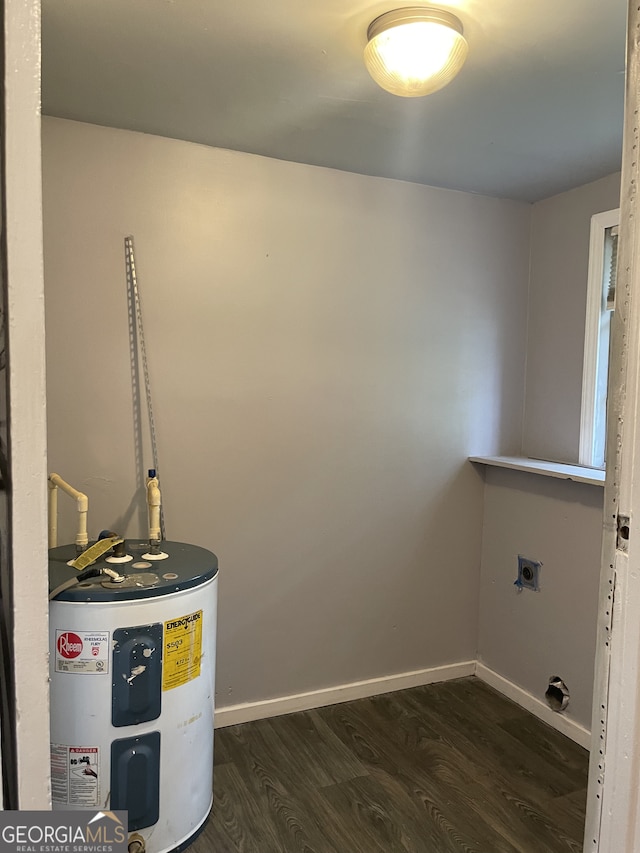 washroom with electric water heater, dark hardwood / wood-style floors, and hookup for an electric dryer