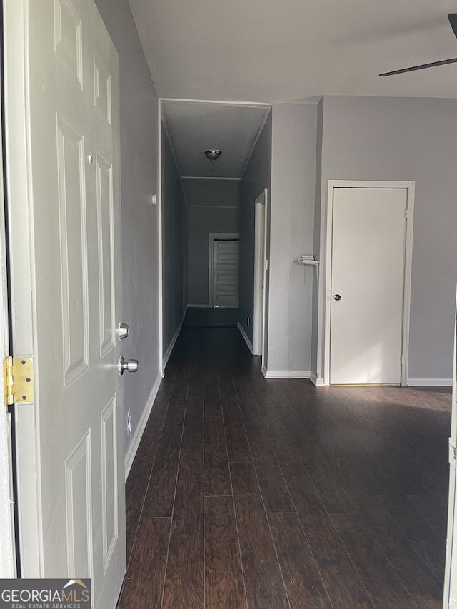 corridor with dark hardwood / wood-style floors