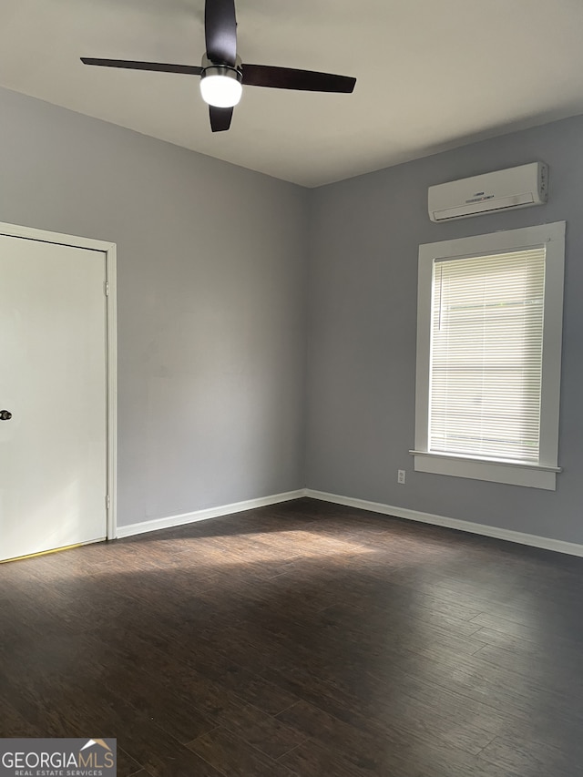 unfurnished room featuring dark hardwood / wood-style floors, ceiling fan, and a wall unit AC