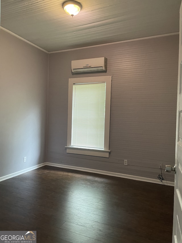 unfurnished room featuring dark hardwood / wood-style flooring, a wall mounted AC, and crown molding