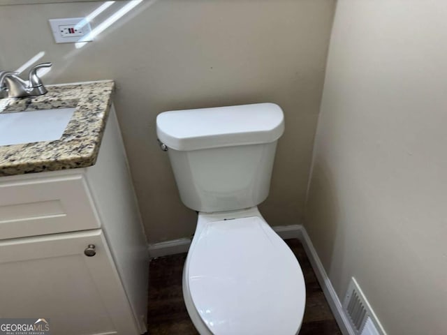 bathroom featuring vanity and toilet