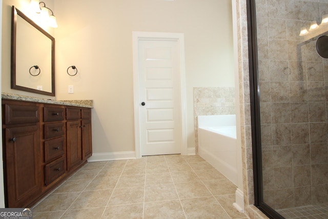 bathroom with a tub, tile patterned flooring, and vanity