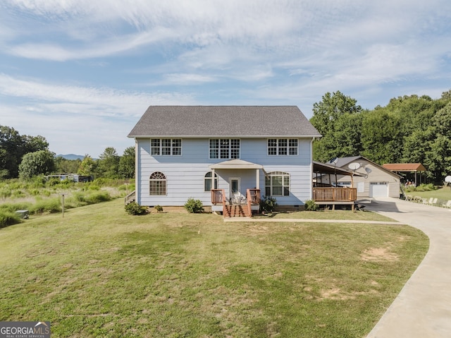 view of front facade featuring a garage, a deck, a front lawn, and an outdoor structure