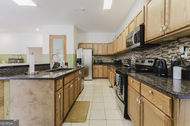 kitchen featuring light tile patterned flooring, sink, appliances with stainless steel finishes, and tasteful backsplash