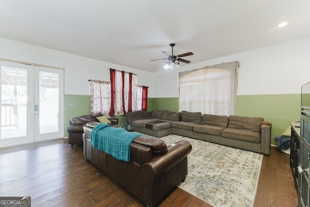 living room with ceiling fan and dark hardwood / wood-style flooring