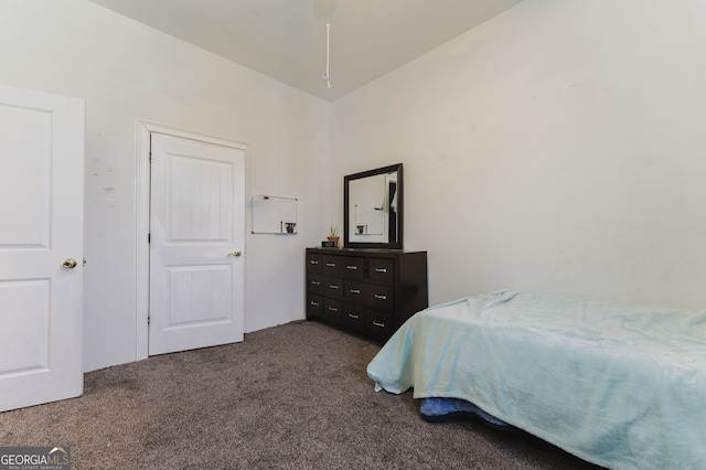 bedroom featuring dark carpet