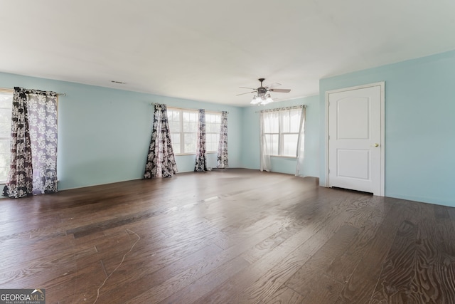 spare room featuring dark hardwood / wood-style flooring and ceiling fan