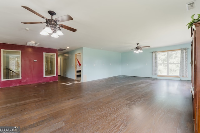 unfurnished living room featuring dark hardwood / wood-style floors and ceiling fan