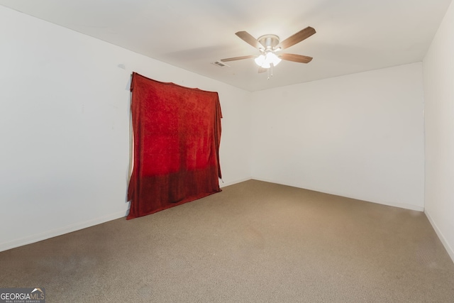 empty room featuring carpet flooring and ceiling fan