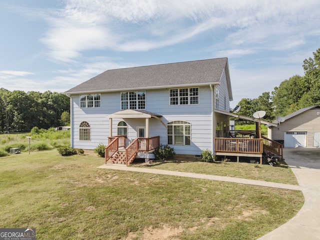 view of front of home with a front lawn, an outdoor structure, and a garage