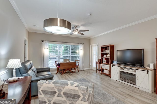 living room featuring ceiling fan, light wood-type flooring, and ornamental molding