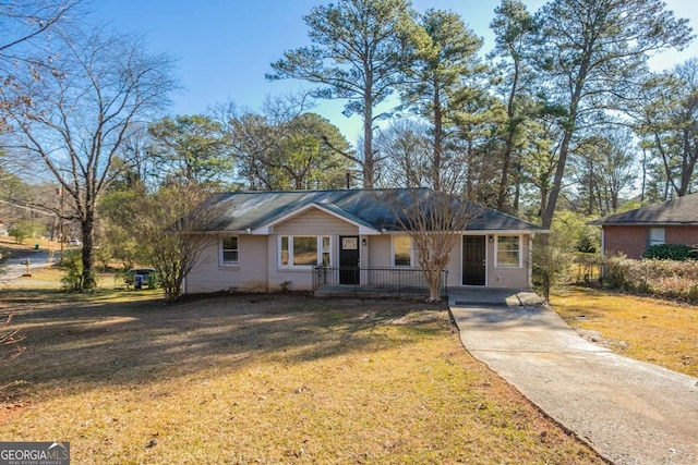 ranch-style house featuring a front yard and a carport