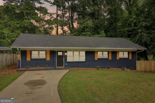 ranch-style home featuring a lawn