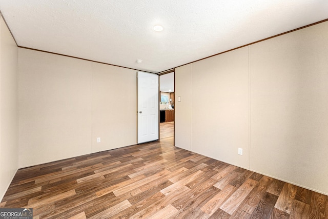 empty room featuring hardwood / wood-style floors and a textured ceiling