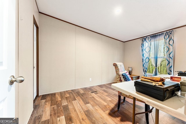 office space featuring wood-type flooring and ornamental molding