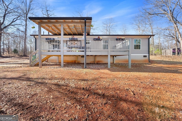 back of property with a wooden deck