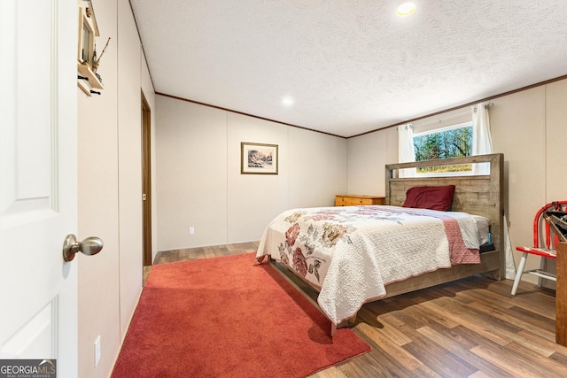 bedroom with wood-type flooring and a textured ceiling