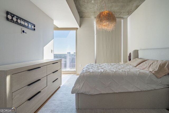 bedroom featuring a closet, a chandelier, and multiple windows