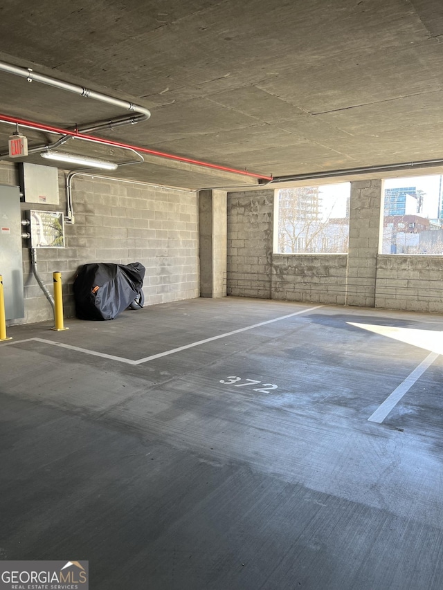 parking garage featuring concrete block wall