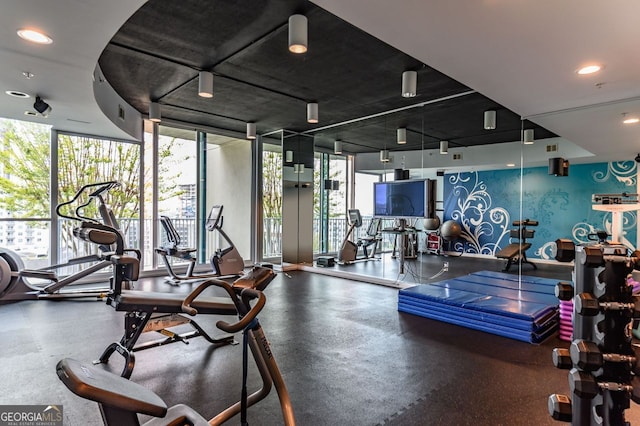 exercise room with a healthy amount of sunlight and a wall of windows