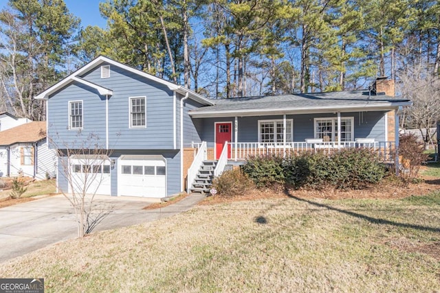 split level home featuring a garage and a front lawn