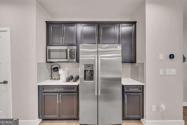 kitchen with appliances with stainless steel finishes and backsplash