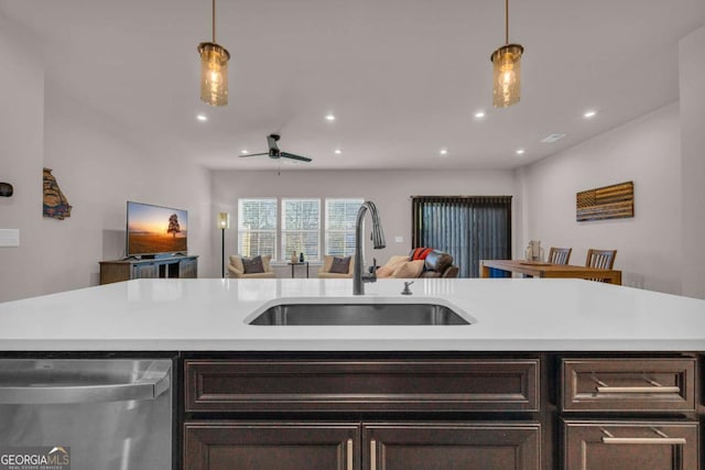 kitchen featuring dark brown cabinets, an island with sink, stainless steel dishwasher, and sink