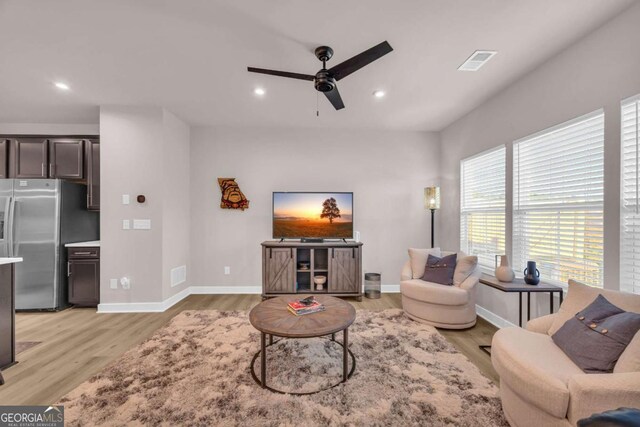 living room featuring ceiling fan and light hardwood / wood-style floors