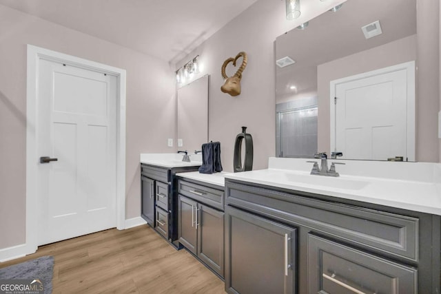 bathroom with vanity, hardwood / wood-style flooring, and walk in shower