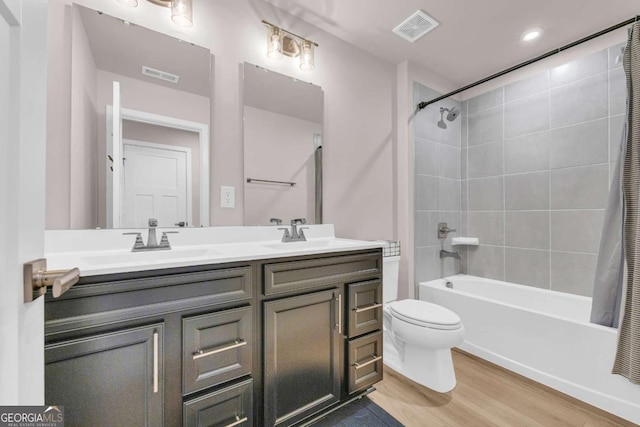 full bathroom featuring toilet, vanity, shower / bath combination with curtain, and hardwood / wood-style flooring