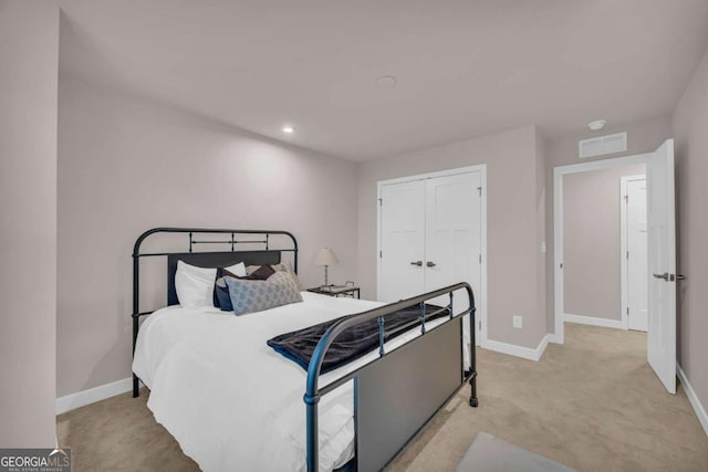 carpeted bedroom with a closet