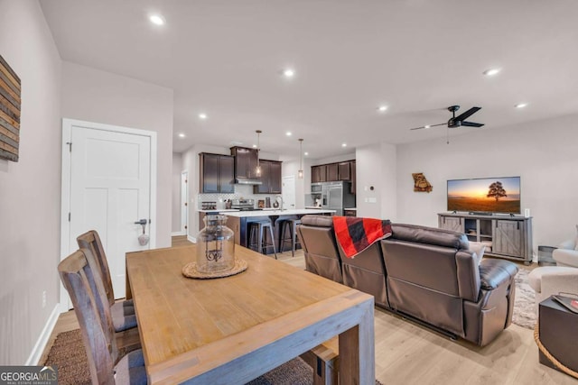 dining room featuring ceiling fan and light hardwood / wood-style flooring