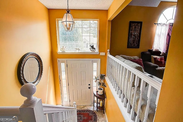 entryway with a notable chandelier