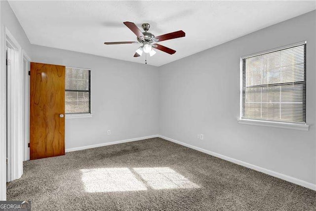 carpeted empty room featuring ceiling fan