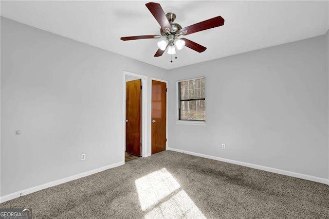 empty room with carpet flooring and ceiling fan