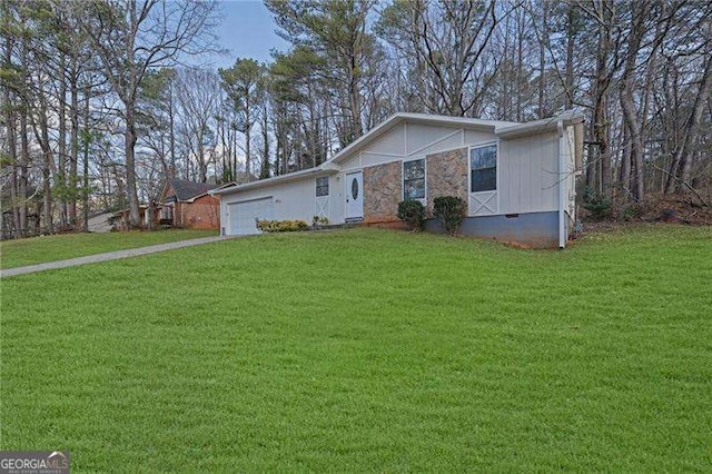 single story home featuring a garage and a front yard