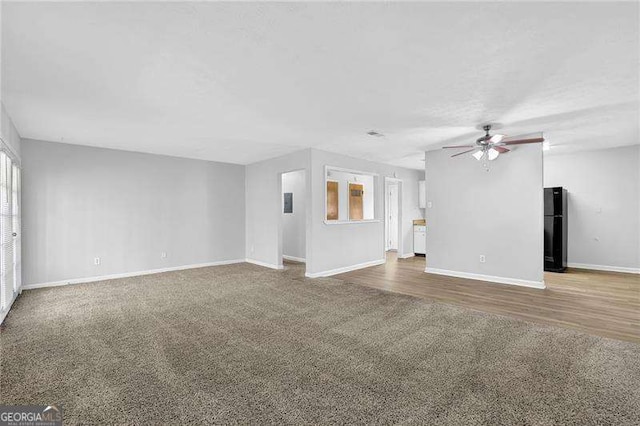 unfurnished living room with ceiling fan and carpet floors