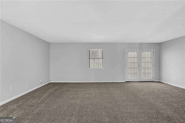 unfurnished room featuring carpet and french doors