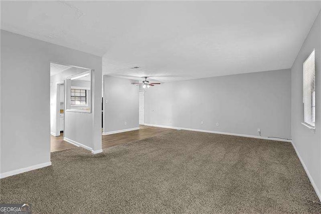 unfurnished living room with carpet flooring and ceiling fan