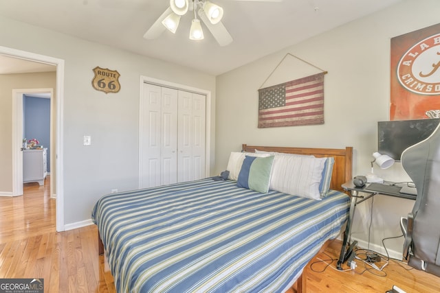 bedroom with ceiling fan, a closet, and light hardwood / wood-style flooring