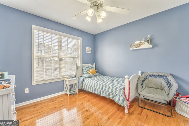 bedroom with hardwood / wood-style flooring and ceiling fan