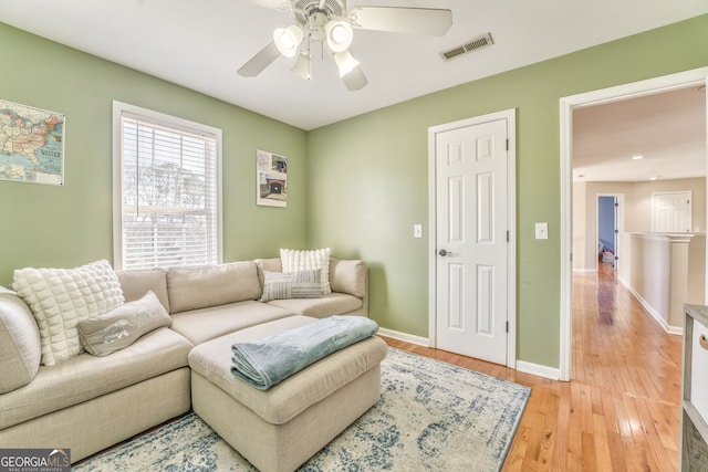 living room with ceiling fan and light hardwood / wood-style floors