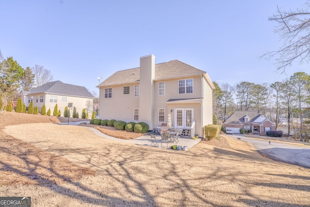 back of house with french doors and a patio