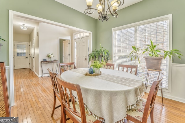 dining room featuring an inviting chandelier and light hardwood / wood-style flooring