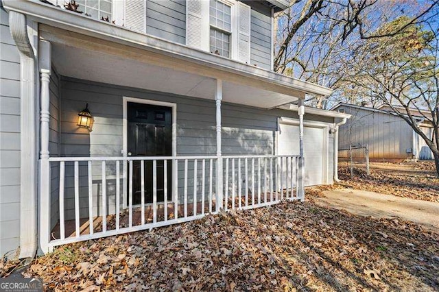 view of home's exterior with covered porch and a garage