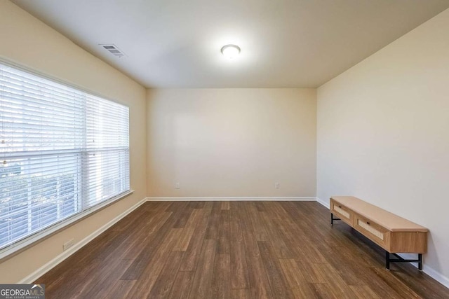 spare room featuring dark hardwood / wood-style floors