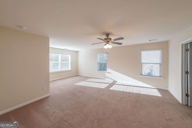 unfurnished room with light carpet and ceiling fan