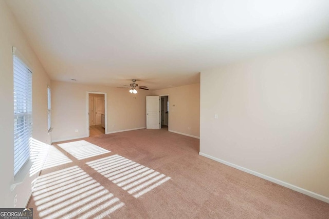 carpeted spare room with ceiling fan